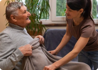 Elderly man smiling at nurse